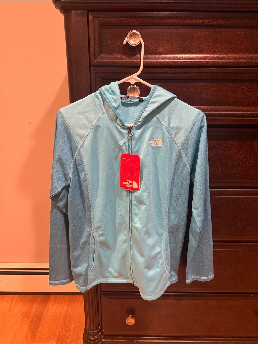 The North Face Youth Light Blue Hooded Fleece Zip Jacket.